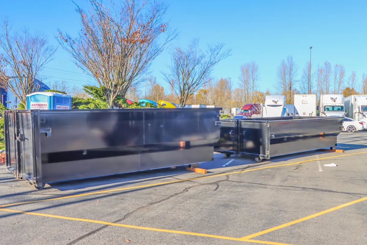 Professional dumpster rental service with roll-off container on residential driveway in Poolesville